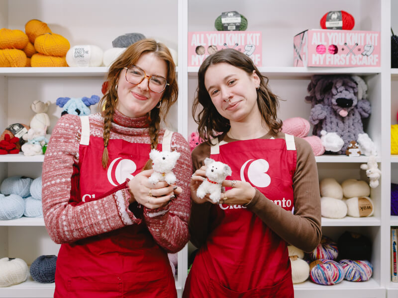 Women showing off their handmade plushies